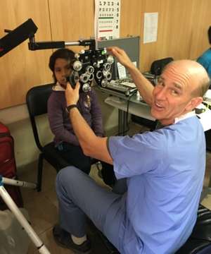volunteer giving a vision test